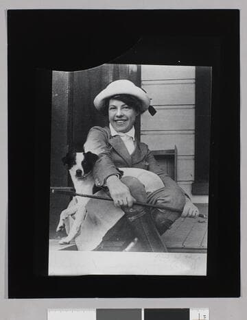 Charmian London on a cottage porch with a dog