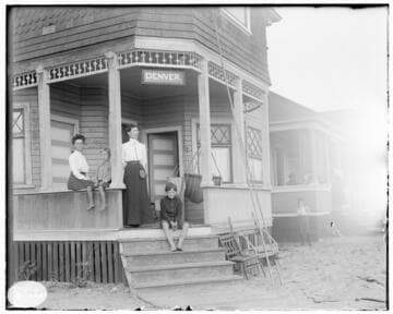 Two women and two young boys at a beach house labeled "Denver