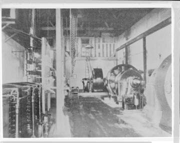 The interior of Mill Creek #1 Hydro Plant. showing the generators. the switchboard. and the Pelton wheels