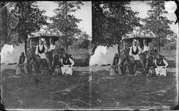 Comanche Indian group at temporary camp. At left, Cheevers and his two wives, Tabenanaka (seated, far right) and his wife, and unidentified men standing behind