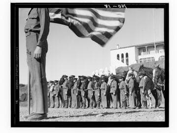 Boys standing with horses and American flag, Urban Military Academy, Brentwood, Los Angeles
