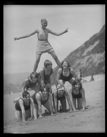 Scouts make a human pyramid on the beach at Santa Monica Girl Scout camp