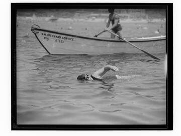 Swim meet winner swimming at the Yacht Harbor breakwater dedication, Santa Monica
