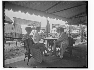 Swim team at a table at the Club Casa del Mar, Santa Monica, California