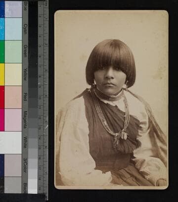 Portrait of possibly an Apache or Pueblo Indian woman wearing beaded necklace
