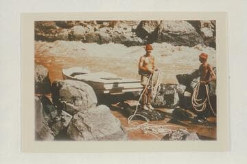 Nevills and Frost pose with the lines after lining a sadiron down Vulcan Rapid. The sadiron is pulled up on the rocks for reloading