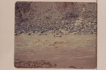 Les Jones in his canoe-type of boat in Dubendorff Rapid. "Jones ran it down the middle. Really disappeared in a hole." Smith journal entry