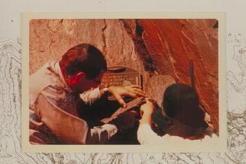 Jim Bailey and Frankie Strathairn fasten the 1934 plaque in place for the drying of the adhesive; Separation Canyon