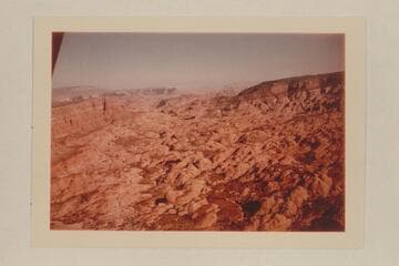 Down Forbidding Canyon; Fifty Mile Mountain at upper left;  the Henry Mountains in the haze in the distance;  Cummings Mesa at left