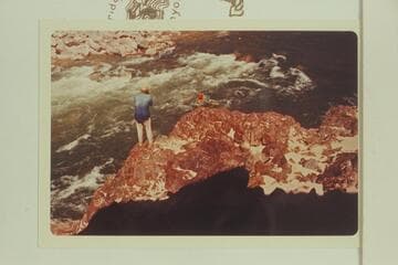 Bill Belknap on left bank at Gneiss Canyon Rapid, photographs test run of Sportyak