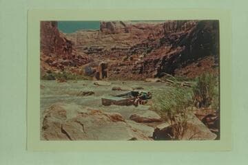 Lining one of the Frost punts on the San Juan River- Skipper Frank E. Frost in front, William A. Rowan and Arch H. Rowan, Jr.   Syncline Rapid in high water