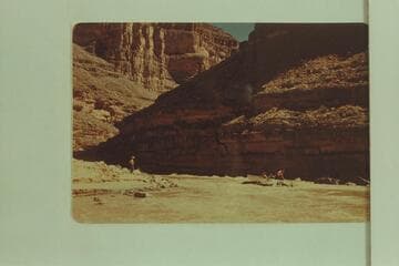 Miscue by George Wing on his first trip in 1947, May which set Nevills's antipathy.  The punt is hung on the rock.  The other three boats have landed and Nevills is standing on shore giving instructions to Wing.  Flow is less than 1100 cfs