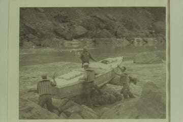 Portage of Caltech boat at Vulcan Rapid.  Frank Dodge is on the port side of the boat.  Owen Clark, Merrill Spencer, and Ian Campbell are inshore