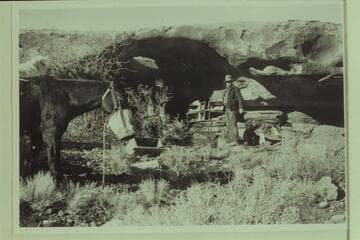 In camp. Opening in back of cave appears to establish a small arch