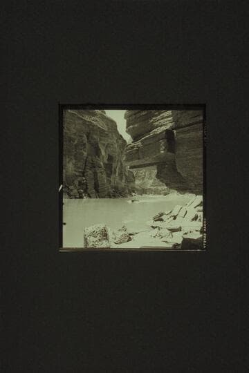 One of the boats coming back up the river after examination of Upset Rapid, Mile 150.  Lunch had been under the overhang