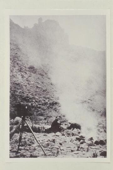 Russell sitting by the fire. The party was in the middle of Cataract Canyon