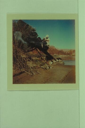 The buckets on the dredge of the Hoskanini Mining Company in Glen Canyon, with Frank Wright giving the scale