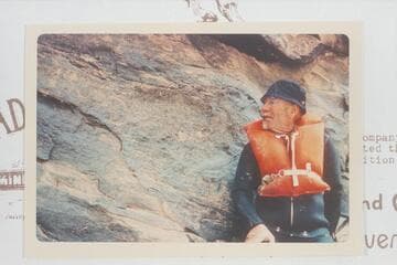 Dock Marston posed at the 1836 D Julien inscription in Cataract Canyon at Mile 185.75.  Later Visitors belieVed they deciphered an inscription to the right reading D/GCMICo/1891