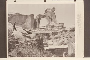Angel Arch (Pegasus Arch).  Tributary of Salt Creek Canyon.  Kent Frost at left.  [on reverse, handwritten:   technical description of print]