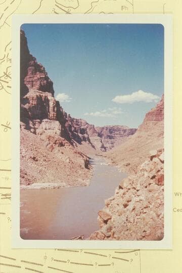 Up Cataract Canyon from Mile 203.1.  The island at Mile 203 breaks the water at lower left margin.  Rapid No. 19 is in the middle distance--Mile 203.7 and dropping 6 ft. in 0.2 miles.  This is Stanton's Hells Half Mile.  Compare Reilly photo 9 5 60