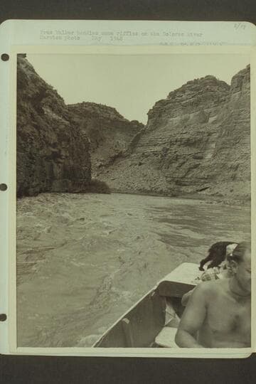 Pres Walker handles some riffles on the Dolores River.  [photo reverse:  "Quiet stretch of Dolores"--485 DO 114]