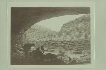 Margaret Marston and Becky Walker dig in the ruins of the Basket Makers Cave on the Dolores River while Pres Walker drags on a cigarette. Ditty at the right