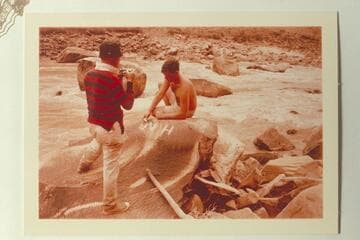 Dock Marston photographing the McDonald inscription at Best Wreck Rapid--Mile 204.55 right bank in Cataract Canyon