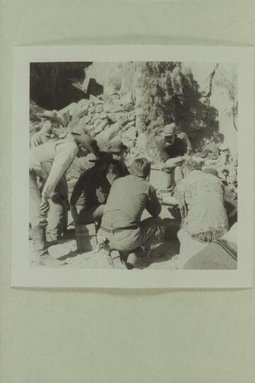 The cast of "The Colorado River Story" study action at a camp site opposite Kings Bottom below Moab.  Disney crew.  David Stollery; Ben Johnson; John Beal; Bob Armstrong; L. Q. Jones; Dan Sheridan; Brian Keith; Stan Jones is hidden except for his hat