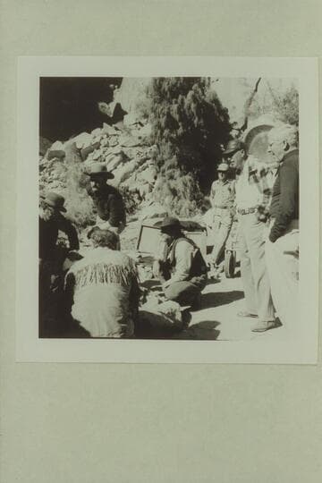 Cast discussing action at camp site below Moab. "Colorado River Story" filmed by Disney. Bob Armstrong; Dan Sheridan; Brian Keith; Stan Jones. Director Bill Beadine and Cameraman Gordon Avil at right