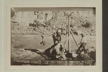Emery and Tasker.Salvage operations to recover boat trapped in rocks at Dark Canyon Rapids. USGS party directed by W. R. Chenoweth. In LaRue album #1 the credit is to L. Lint. "Ready to Go Out," Lint Album. Copy of small print loaned by Chenoweth