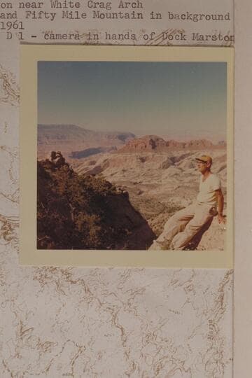 Ballard Atherton near White Crag Arch. Rainbow Butte and Fifty Mile Mountain in background