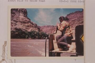 Virginia Hough at some close photography as she sits on the bow of the "Bert Loper." About Mile 60 below Moab