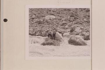 The "Joan" locked on the rocks in Cataract Canyon.  Rapid 23.  She was finally released and rolled over, cracking the decking.  [above print, in pencil:  reversed?]