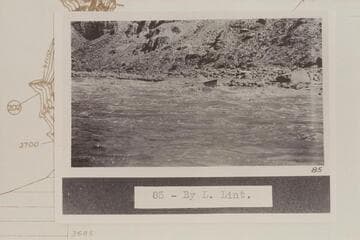 The flat-decked USGS skiff in Rapid No. 20.  Rapid No. 20 heads at Mile 203.15 and drops 8 ft. in .15 miles.  The boat is at the lower end of the island.  Compare 64-3-31 CTCN 203-13