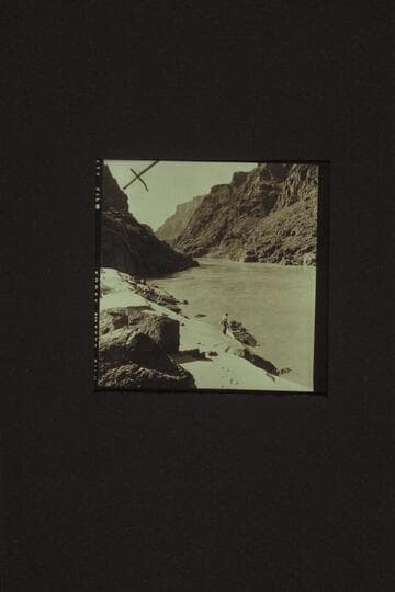 Down river from the cove above Bridge Canyon Rapid, Mile 234.9.  Jim Jordan and the "JUNE BUG" at the beach