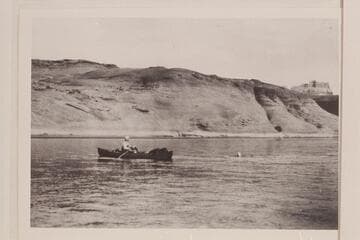 Sarah Fraser swimming across the river at El Vado.  Burt Loper in rowing the folding canvas boat.  Photo copied from album of Sarah Fraser Robbins