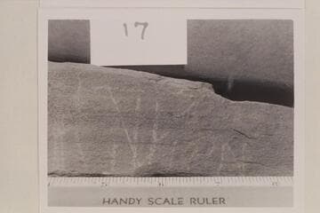 Scratches on rock slab which was taken from the Fort at the mouth of White Canyon. It appears to say "Julian" and is on the right side