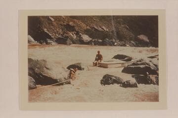 Lining a Nevills sadiron at Vulcan Rapid. Garth Marston is in the river. Nevills sits on the deck