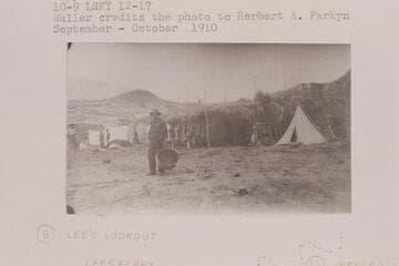 The Fort at Lees Ferry converted into a cook house and surrounded by tents for the first camp of the placer crew in the Spencer operations.  Copy of print #12 in Waller collection.  Waller credits the photo to Parkyn