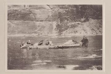 Pat Flattum dragging outboard motorboat through shallows in Glen Canyon