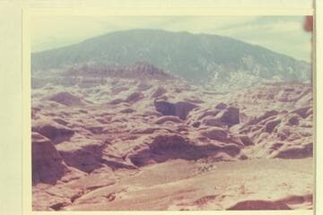 Across the cactus flat drained by Black Water Creek and the small dry stream bed at Mile 71.  Butte 6069 at left above center.  Butte 5014 at right center
