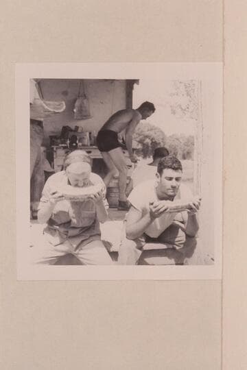Shirley and Garth Marston eat melons.  Island Park; Ruple Ranch