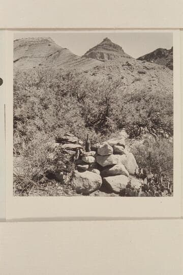 Monument on right bank of Chuar Creek. Bottle was inside. West side of Chuar Creek just north of Butte Fault. Nine workings are west and south of this monument about 100 yds. In area of Morning Star Mine and Rogers Claim