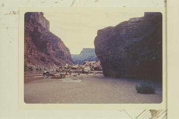 Camp on sand bar at overhanging rock above 25 Mile Rapid. The rock at right may be Hansbrough-Richards Ledge, Mile 24.85