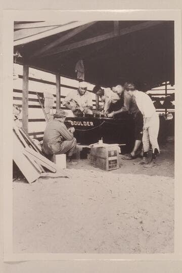 Conditioning the boats at Lees Ferry. Lint album. Completing repairs on the "Boulder." In semi circle left to right: Lint, Blake, Freeman, Kolb