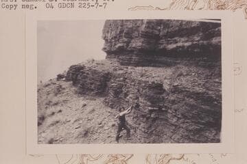 John S. Wilbur swinging a pick in his prospecting in the general area of the mouth of Diamond Creek and up to Fall Canyon