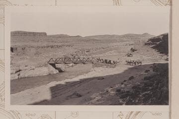 Spencer pack outfit at the bridge across the San Juan River below Mexican Hat.  C. H. Spencer leading on his horse "Chunk."  He remarked at the time that it was the first time in his many crossings of the San Juan that he felt safe