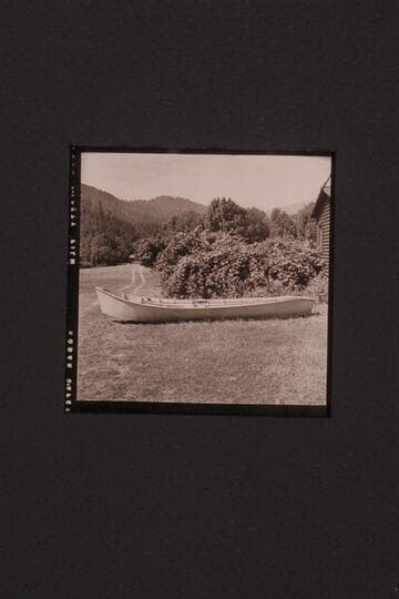 Rogue River type of boat.  Two boats at Agness on the Rogue River.  Outboard motor on stern of one boat