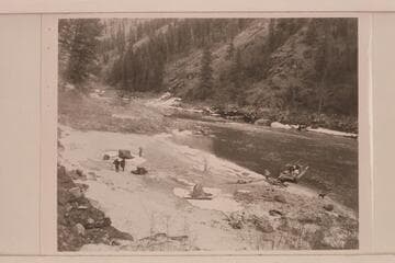Camp on the icy beach. The tent being rigged on the scow. The sweeps are put ashore