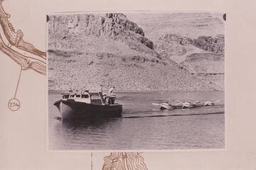 Motorboat piloted by Buzz Holmstrom taking in tow the three sadirons of the Nevills 1938 fleet; near Mile 270